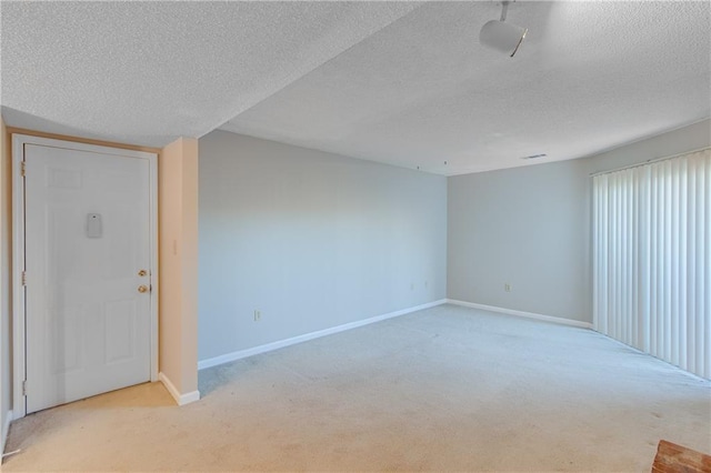 carpeted spare room with a textured ceiling