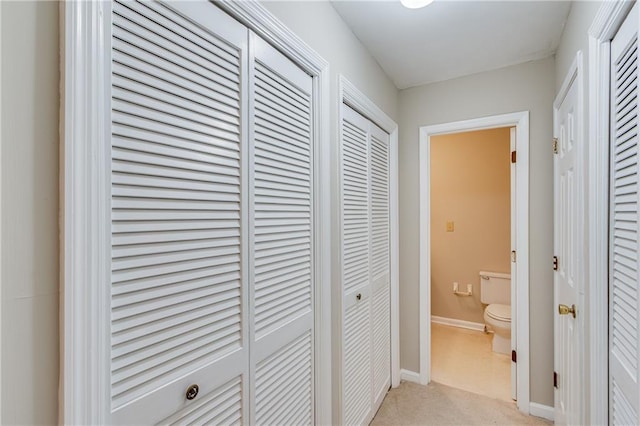 corridor featuring light colored carpet