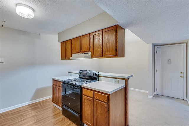 kitchen featuring black range with electric stovetop, light hardwood / wood-style floors, and a textured ceiling