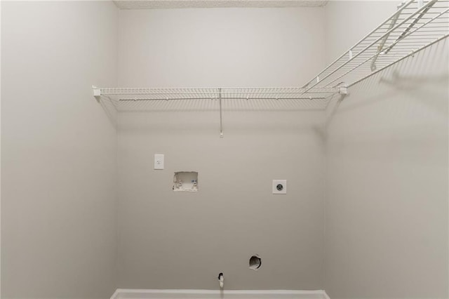 laundry area featuring hookup for an electric dryer, washer hookup, and baseboards