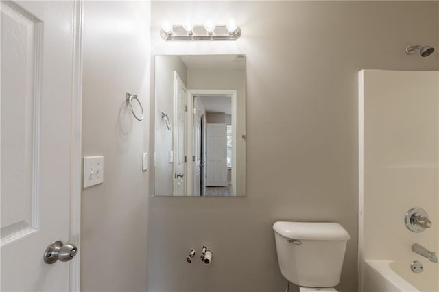 bathroom with toilet and shower / washtub combination