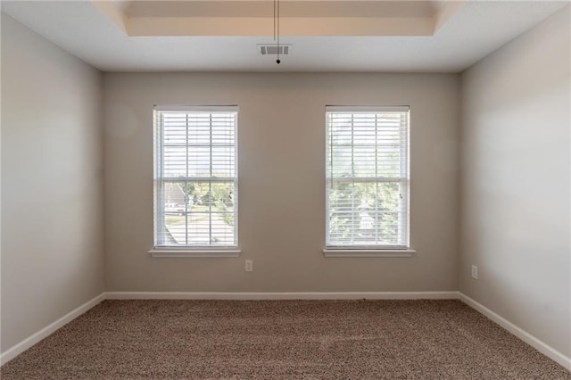 carpeted empty room featuring plenty of natural light and baseboards