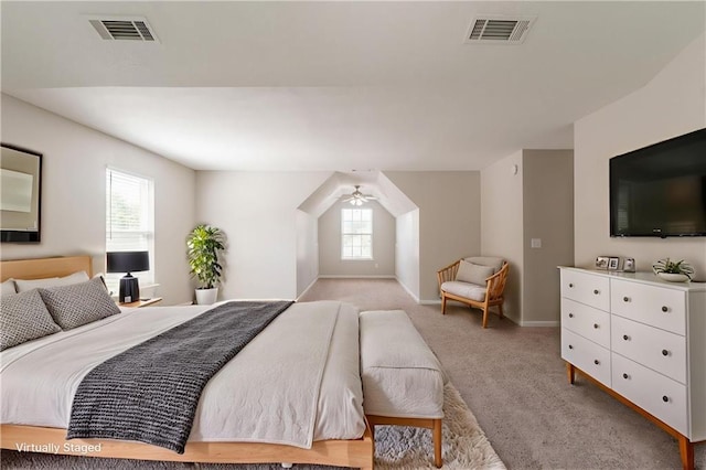 bedroom with light colored carpet and baseboards