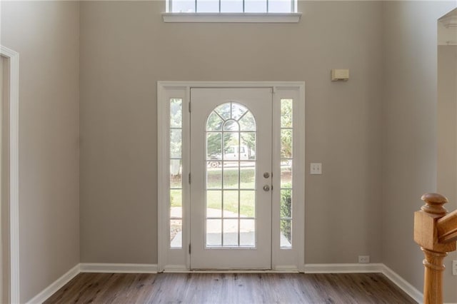 entrance foyer featuring wood finished floors and baseboards