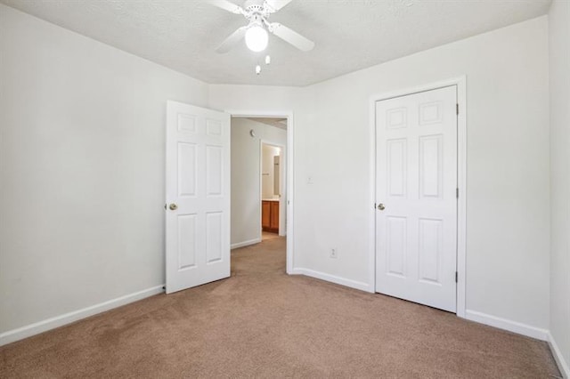 unfurnished bedroom featuring carpet flooring, a closet, and ceiling fan