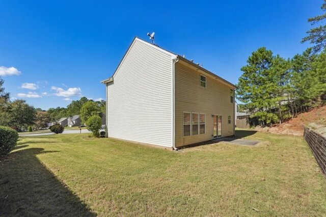 view of property exterior with a yard