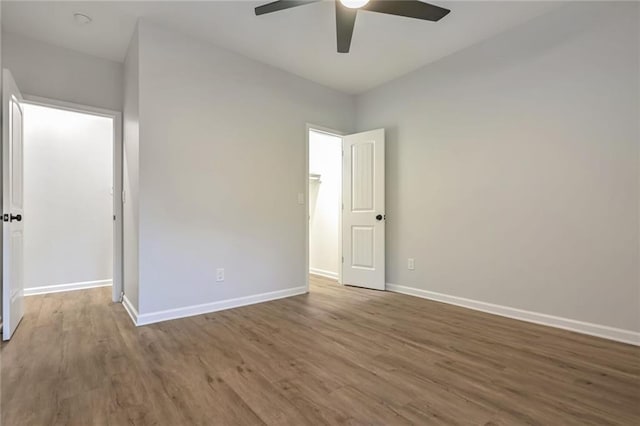 empty room featuring ceiling fan and wood-type flooring