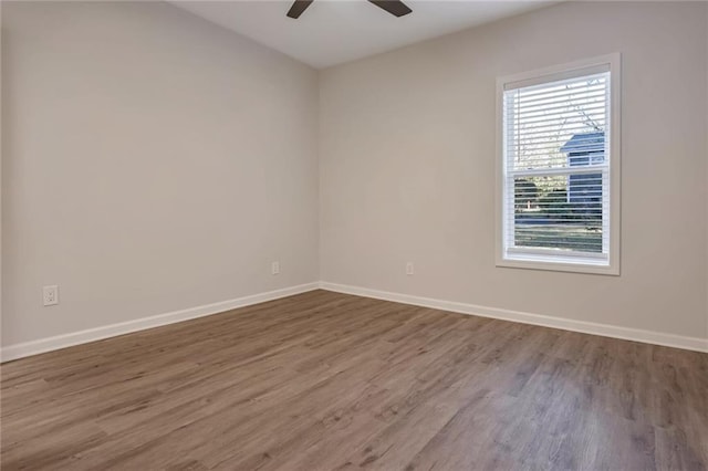 unfurnished room with ceiling fan and hardwood / wood-style floors