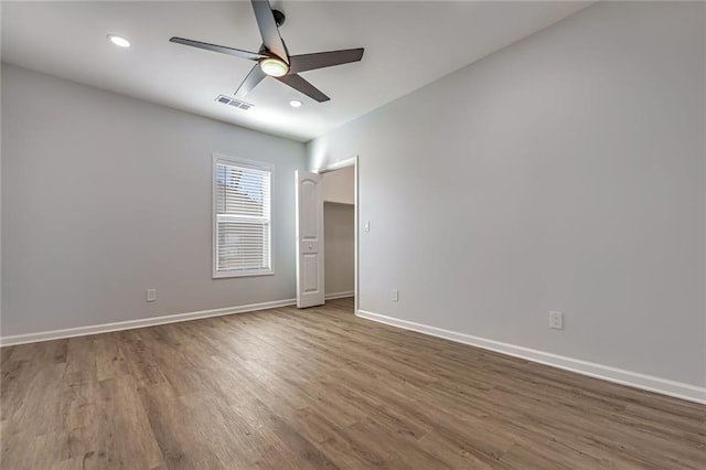 empty room featuring ceiling fan and dark wood-type flooring