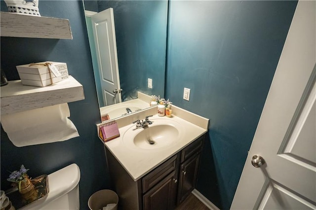 bathroom featuring toilet and vanity