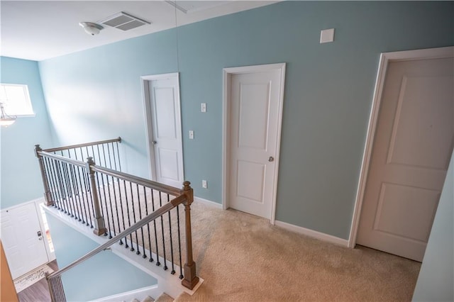 hallway featuring light carpet