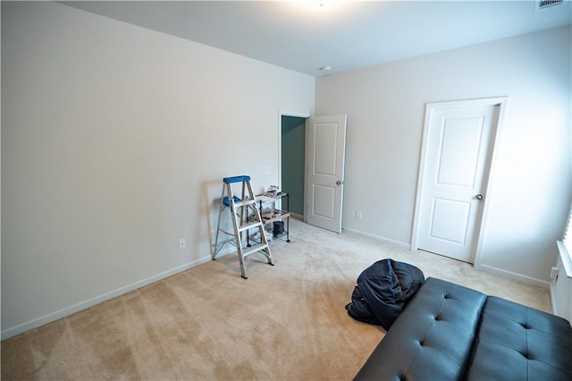 miscellaneous room featuring light colored carpet