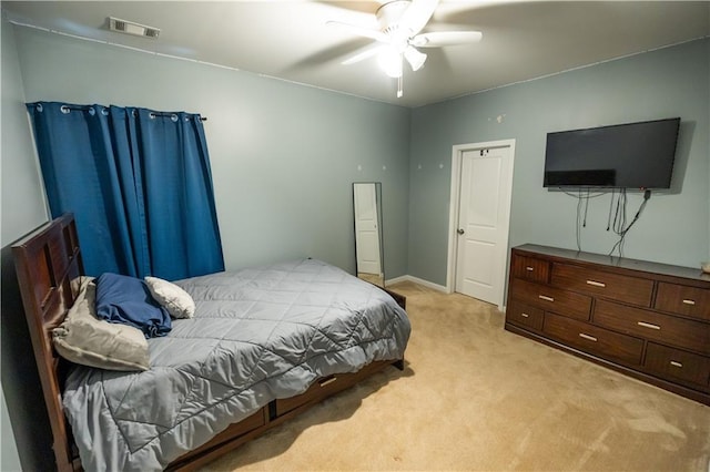 bedroom featuring ceiling fan and light carpet