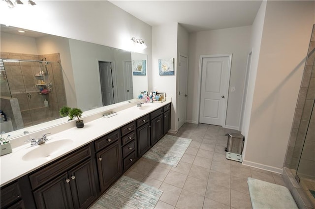 bathroom with tile patterned flooring, walk in shower, and vanity