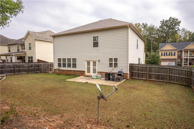 rear view of property featuring french doors, a patio area, and a yard