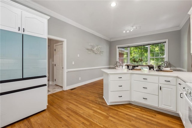 kitchen with white cabinetry, ornamental molding, range, and light wood-type flooring