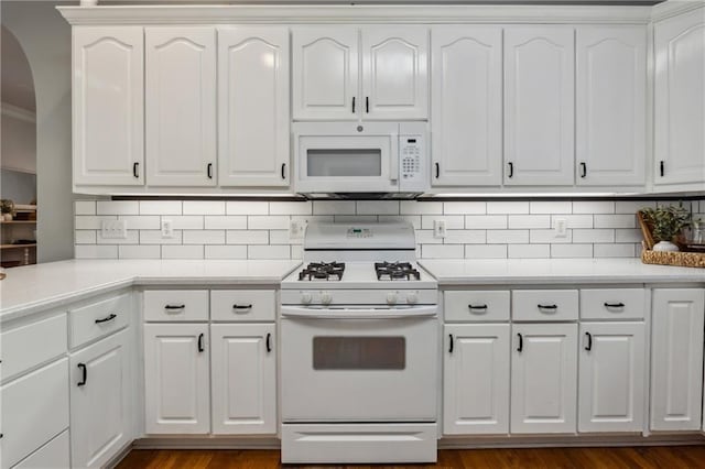 kitchen featuring crown molding, white cabinets, white appliances, and decorative backsplash