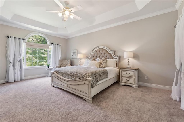 bedroom featuring crown molding, light colored carpet, a raised ceiling, and ceiling fan