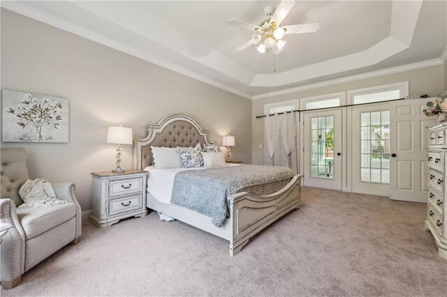 carpeted bedroom featuring a raised ceiling, crown molding, access to outside, and ceiling fan