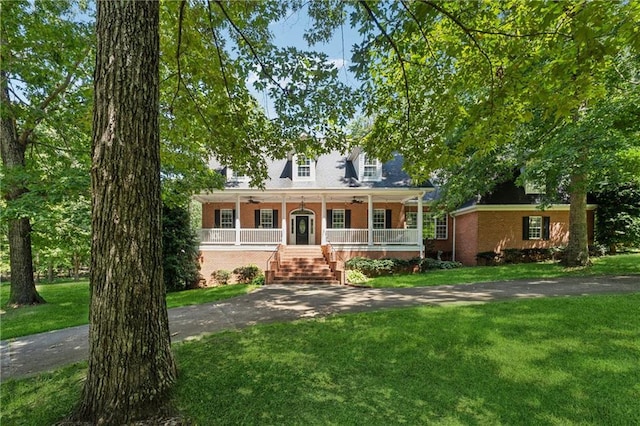 view of front of home with a front yard and covered porch