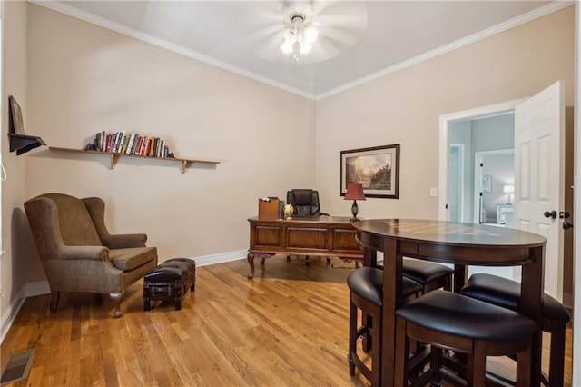 home office with crown molding and light wood-type flooring