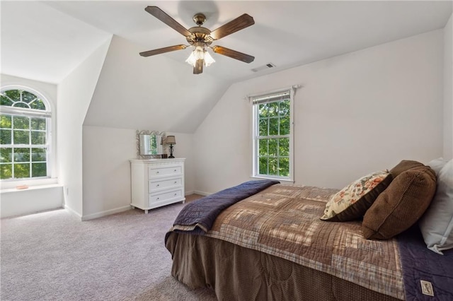 bedroom featuring vaulted ceiling, light colored carpet, and ceiling fan