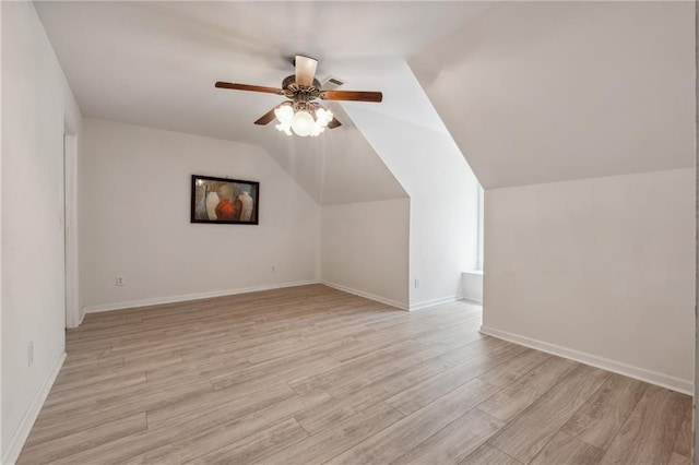 additional living space featuring ceiling fan, vaulted ceiling, and light wood-type flooring