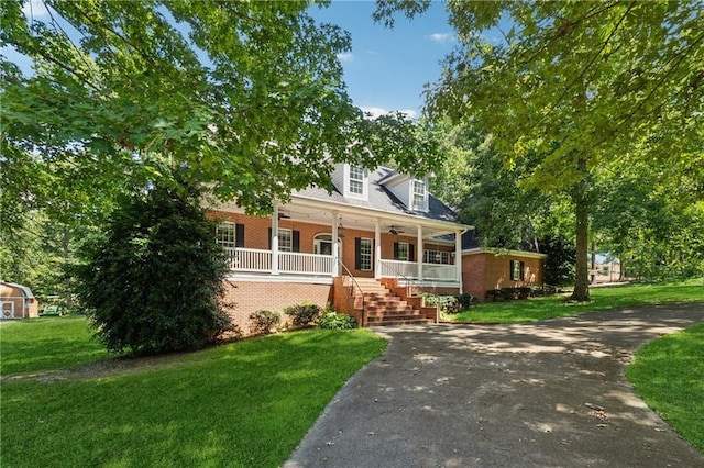 cape cod house featuring a front yard and covered porch