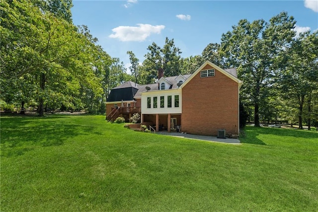 back of property featuring a yard and a deck