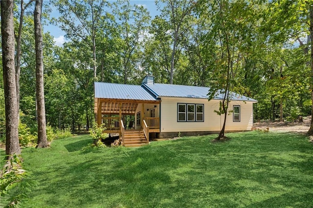 rear view of property with a yard