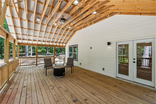 deck with a fire pit and french doors