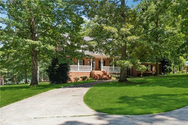 view of front of home with a front yard and a porch