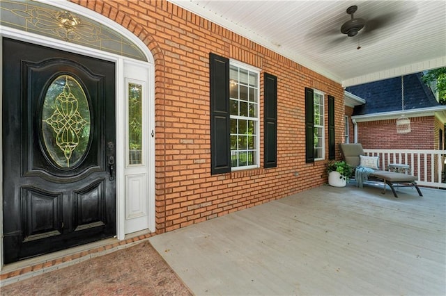 doorway to property with ceiling fan and covered porch