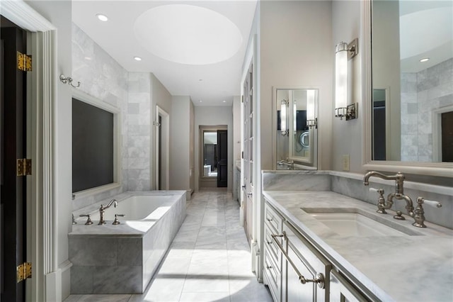 2525 Peachtree Rd Unit 28, Atlanta, GA 30305 - bathroom featuring vanity, a garden tub, marble finish flooring, and recessed lighting