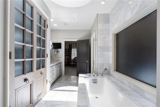 2525 Peachtree Rd Unit 28, Atlanta, GA 30305 - full bathroom with a garden tub, vanity, marble finish floors, and recessed lighting