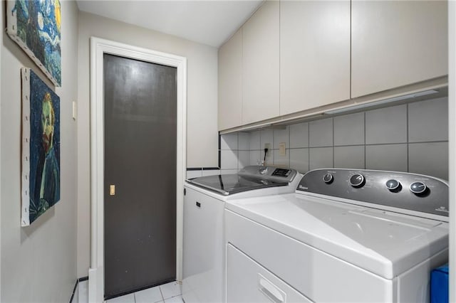 2525 Peachtree Rd Unit 28, Atlanta, GA 30305 - washroom with cabinet space, washing machine and dryer, and light tile patterned floors