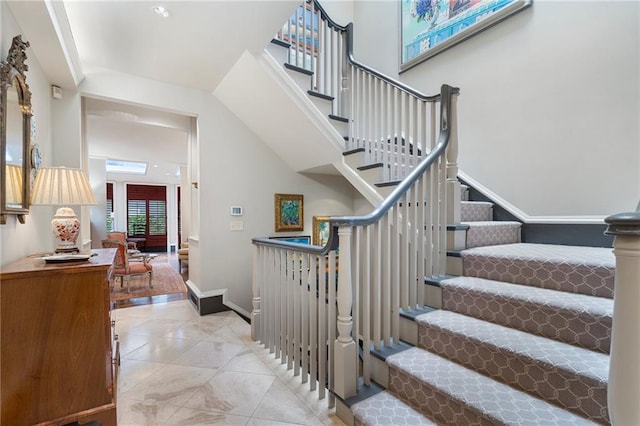 2525 Peachtree Rd Unit 28, Atlanta, GA 30305 - stairway with baseboards and a towering ceiling