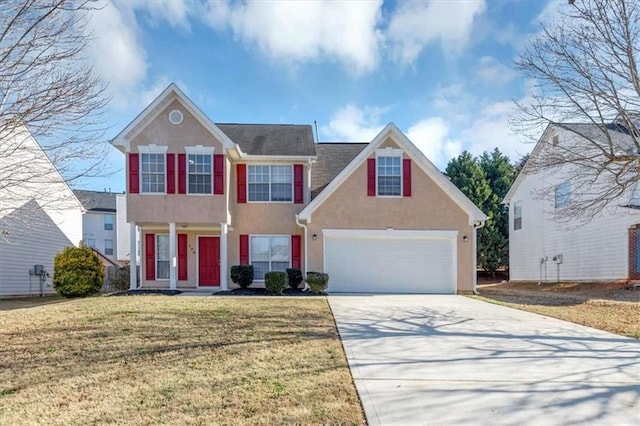 view of front of home featuring a garage and a front yard