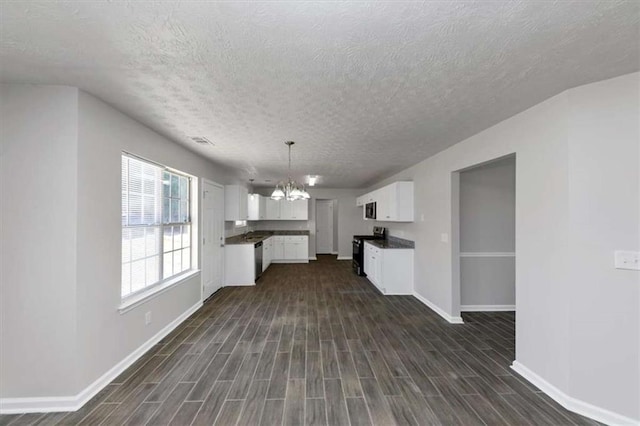 508 Cascade Walk, Mcdonough, GA 30253 - kitchen featuring hanging light fixtures, white cabinets, an inviting chandelier, dark wood-type flooring, and stainless steel appliances