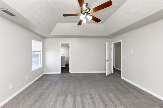 508 Cascade Walk, Mcdonough, GA 30253 - unfurnished bedroom featuring dark carpet, a textured ceiling, ceiling fan, and a raised ceiling