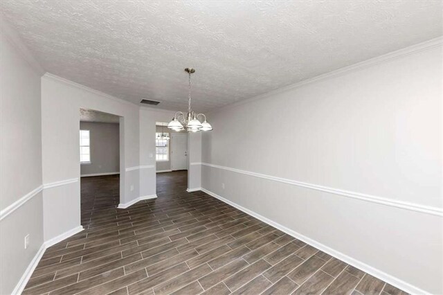 508 Cascade Walk, Mcdonough, GA 30253 - unfurnished dining area featuring a notable chandelier, ornamental molding, and a textured ceiling