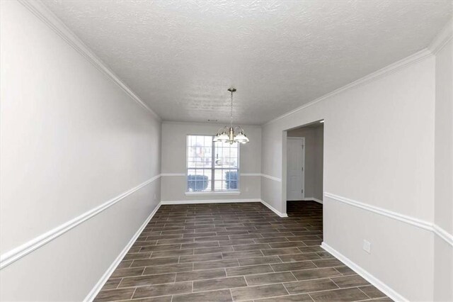 508 Cascade Walk, Mcdonough, GA 30253 - spare room featuring ornamental molding, an inviting chandelier, and a textured ceiling