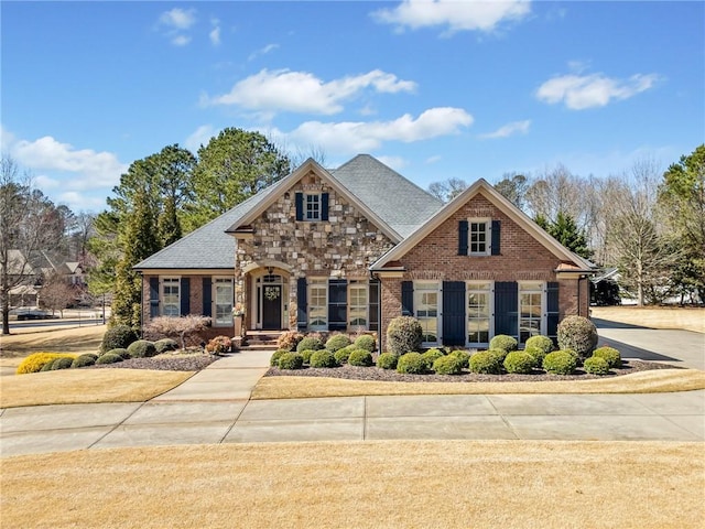 view of front of home featuring brick siding and stone siding