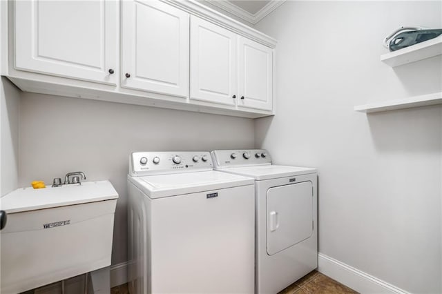 laundry room featuring independent washer and dryer, a sink, cabinet space, tile patterned flooring, and baseboards