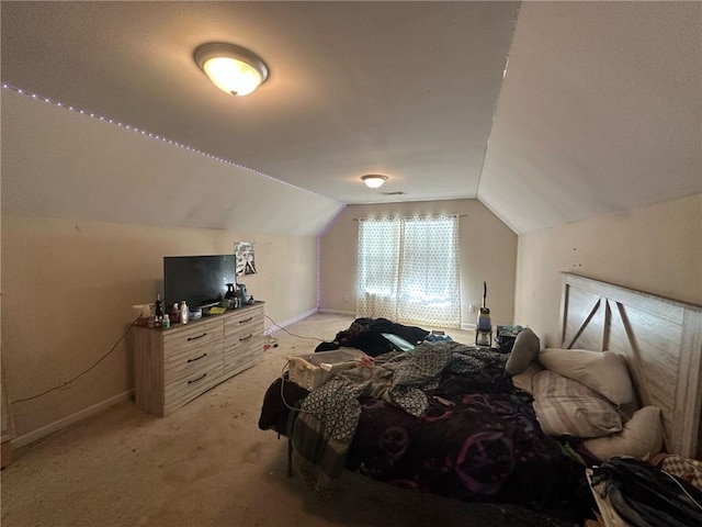 bedroom featuring vaulted ceiling and light colored carpet