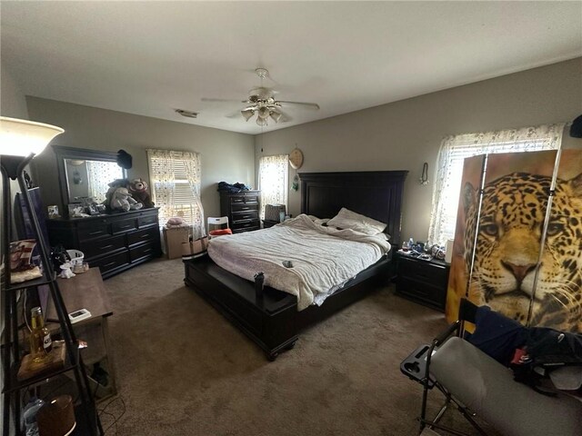 bedroom featuring ceiling fan and dark colored carpet