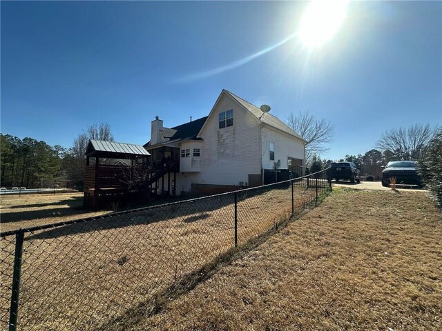 view of side of home with a lawn