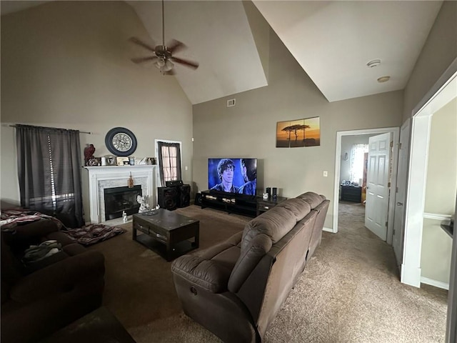 carpeted living room featuring ceiling fan, a premium fireplace, and high vaulted ceiling