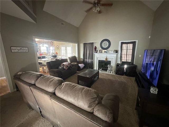 living room featuring ceiling fan, carpet floors, and high vaulted ceiling