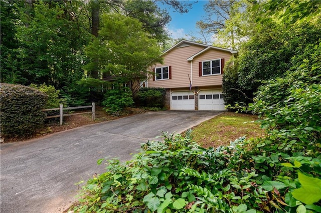 4324 Japonica Ct SW, Lilburn, GA 30047 - view of front facade featuring driveway and an attached garage